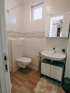 a bathroom with a toilet and a sink at Evropa Sombor in Sombor