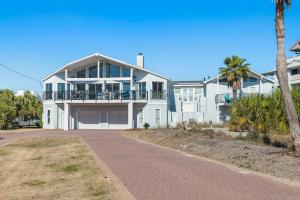 a large white house with a porch and a driveway at Sea-Esta in Destin