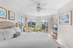 a bedroom with a bed and a ceiling fan at Sea-Esta in Destin +73 photos