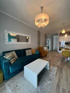 a living room with a blue couch and a table at Your Home Montenegro in Dobra Voda
