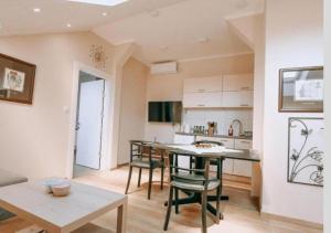 a kitchen with a table and chairs in a room at Evropa Sombor in Sombor +21 photos