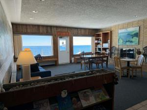 a living room with a view of the ocean at The Shoreline Inn in Grand Marais