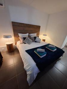 a bedroom with a large bed with towels on it at Kéloué in Saint-François +11 photos