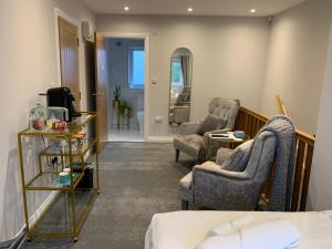 a hotel room with two chairs and a bed at Park View Guest Suite in South Milford +3 photos