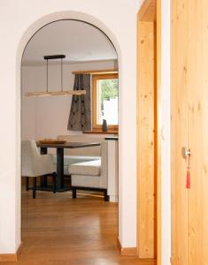 an archway leading into a dining room with a table at Premium Apartment Grischuna 1-8 Pers in Klosters