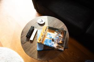 a book and a remote control on a table at Premium Apartment Grischuna 1-8 Pers in Klosters