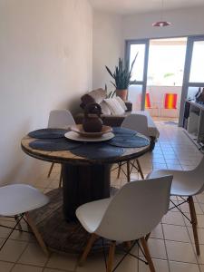 a table with a hat on it in a living room at Barrah flat in Barra de São Miguel
