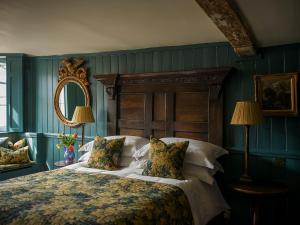 a bedroom with a large bed and a mirror at Hazlitt's in London
