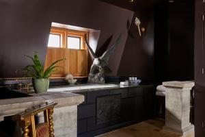 a bathroom with a statue of an eagle on the wall at Hazlitt's in London +88 photos