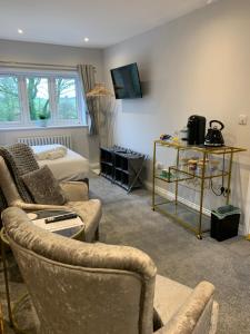 a living room with a couch and a bed at Park View Guest Suite in South Milford
