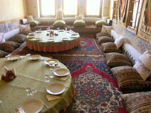 a living room with couches and a table with plates and glasses at Old Greek House in Urgup