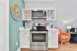 a kitchen with a stove and a microwave at Old Rag Mountain Getaway - WiFi, Smart TV, Fire Pit, Patio, & Full Kitchen in Etlan
