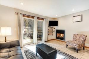 a living room with a couch and a chair and a fireplace at Ground level Condo near Downtown Bend in Bend