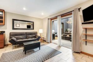 a living room with a couch and a television at Ground level Condo near Downtown Bend in Bend