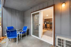 a dining room with blue chairs and a table at Ground level Condo near Downtown Bend in Bend +32 photos