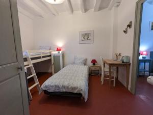 a bedroom with a bed and a desk and a bunk bed at Le Tintamarre - Chambres et suite familiale à 5 min du Zoo de Beauval in Saint-Aignan