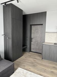 a living room with a door to a room with wood at Bavaro apartments 2 in Ivano-Frankivsk