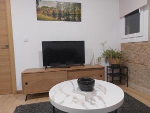 a living room with a tv on top of a table at Casa MENDEZ - ALLARIZ in Ourense