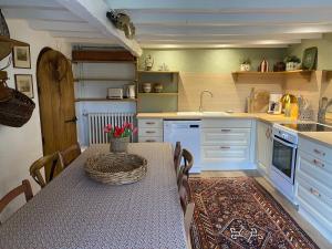a kitchen with a table and a sink and a counter at Le Montillon in Tour-en-Sologne