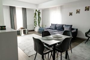 a living room with a table and a couch at New Airport Apartment in Sibiu