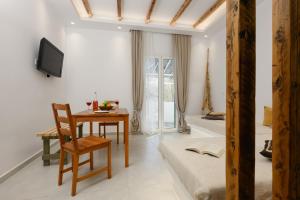 a living room with a table and a chair at Anemomylos in Kastraki