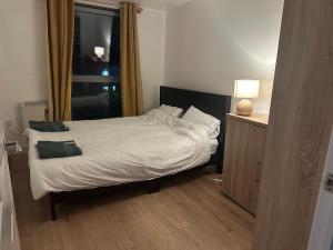 a small bedroom with a bed with a window at Ganmos Place in Bracknell