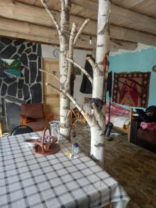 a room with a table with a tree on it at Tusheti Winter Home in Omalo