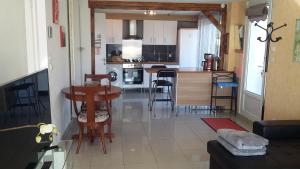 a kitchen and living room with a table and chairs at Gîte du Manival in Saint-Ismier