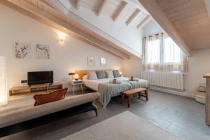 a large living room with a bed and a tv at Sandoñana Old Palace Lodge in Villafufre