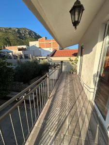 a balcony of a building with a street light on it at Sweet home with a jard Slavica in Šušanj
