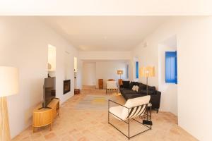 a living room with a couch and a tv at Monte da Torre in Tavira