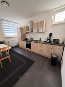 a kitchen with wooden cabinets and a table and a table and a chair at A2 MonteurQuatier Lünen in Lünen