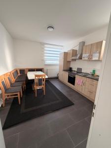 a kitchen with a table and chairs in a room at A2 MonteurQuatier Lünen in Lünen
