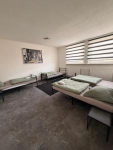 a room with three beds in it with windows at A2 MonteurQuatier Lünen in Lünen