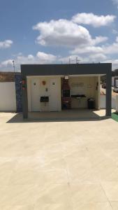 a building with four garage doors and a roof at Flat no Alto de Bezerros Casa 7 in Bezerros
