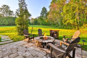 a patio with chairs and a fire pit at Old Rag Mountain Getaway - WiFi, Smart TV, Fire Pit, Patio, & Full Kitchen in Etlan