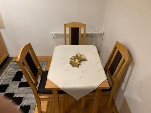 a dining room table with a white table cloth on it at Vila Sana in Landeke