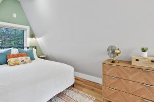 a bedroom with a bed and a dresser at Old Rag Mountain Getaway - WiFi, Smart TV, Fire Pit, Patio, & Full Kitchen in Etlan