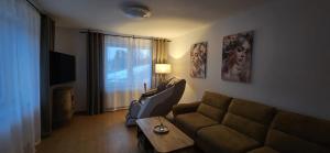 a living room with a couch and a table at ZŁOCKIE HILL spa in Muszyna