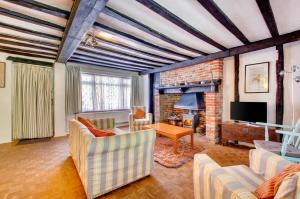 a living room with a couch and a fireplace at 2 Bed in Southwold oc-hdanby in Southwold