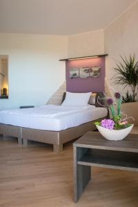 a bedroom with a large bed in a room at Landhotel Zum Hasen Hein in Hamminkeln