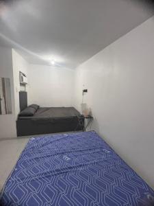 a bedroom with a bed in a room at Alilonch Transient in Mangangbukol