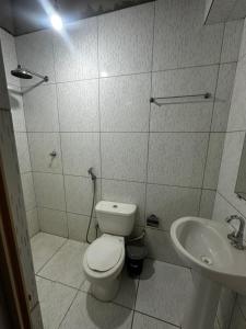 a bathroom with a toilet and a sink at 3R acomodações in Juazeiro do Norte