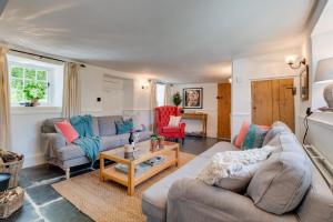 a living room with a couch and a table at 3 Bed in Berrynarbor oc-courtc in Berrynarbor +28 photos