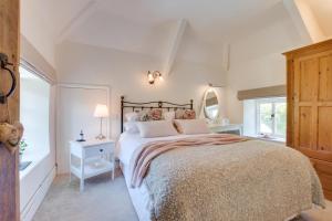 a bedroom with a large bed and a large window at 3 Bed in Berrynarbor oc-courtc in Berrynarbor
