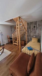 a bedroom with a bunk bed and a staircase at Le Duplex in Vatan