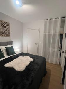 a bedroom with a bed with a black blanket at Secret Garden 2 in Mellehoek