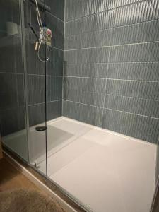 a shower with a glass door in a bathroom at Secret Garden 2 in Mellehoek +14 photos