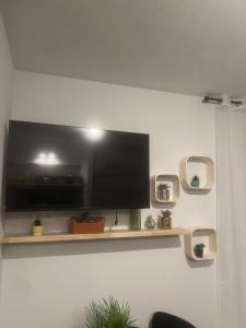 a flat screen tv hanging on a wall at Secret Garden 2 in Mellehoek