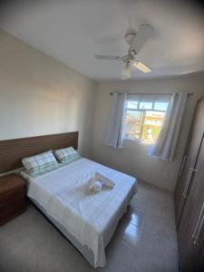 a bedroom with a bed and a ceiling fan at Apê 250m da Orla de Piúma in Piúma
